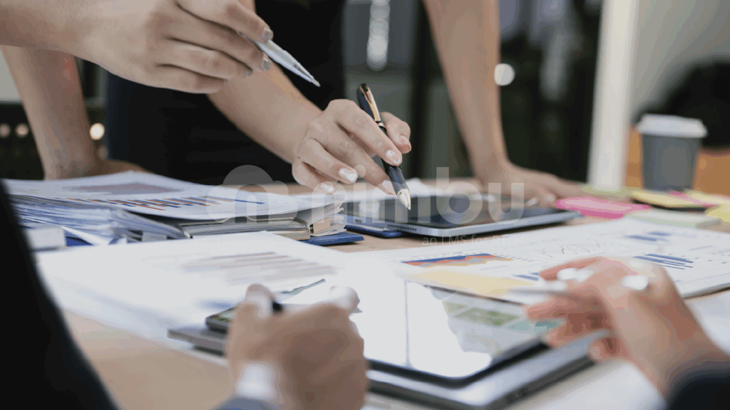 Team reviewing training documents and reports during a planning meeting