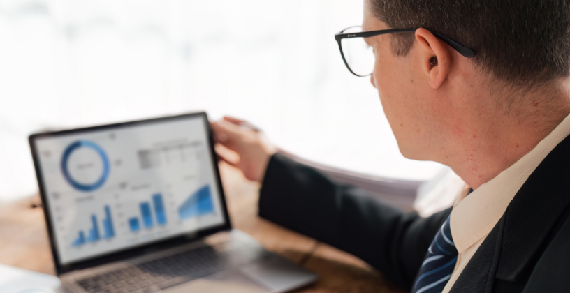 What the New Standards Mean for AVETMISS Reporting Professional reviewing AVETMISS reporting data on a laptop dashboard