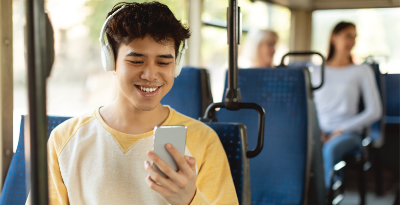 Student accessing mobile learning content on a smartphone while commuting