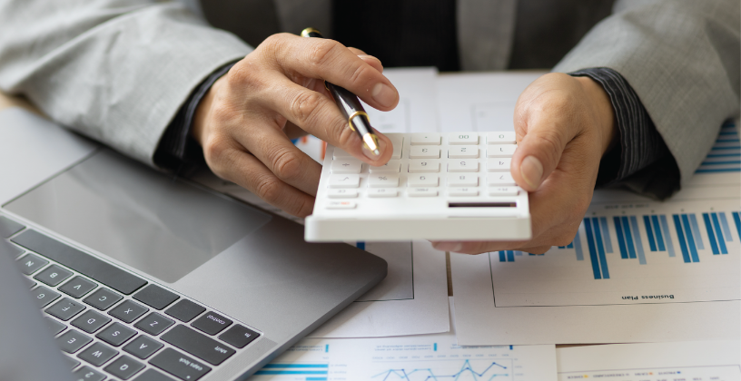Person calculating RTO training costs and reviewing pricing documents