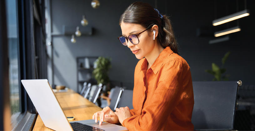 Alt text: Professional using an LMS to manage online training content.