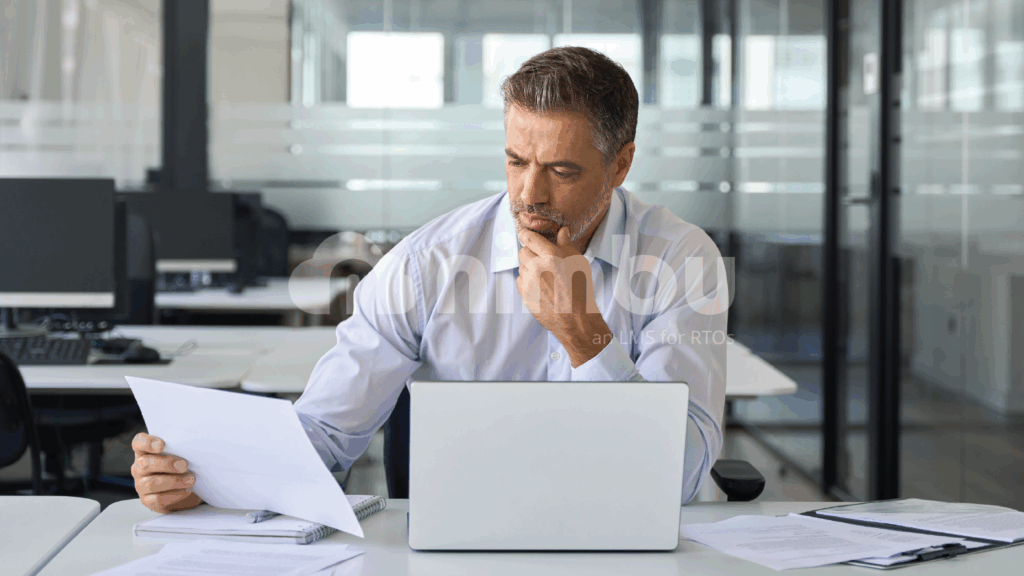 RTO manager reviewing compliance documents and training records on a laptop