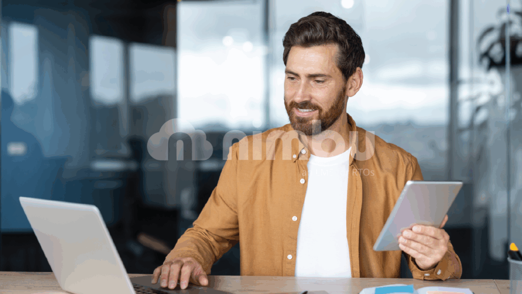 Professional using Nimbu LMS across laptop and tablet for flexible training management.