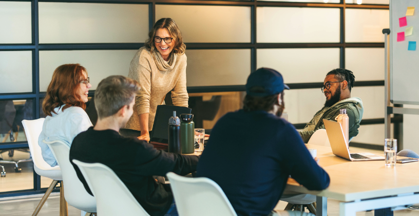 Team participating in a collaborative training session and discussion in a modern meeting room.