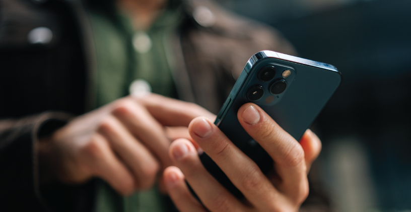 Person using a smartphone to access online learning on the go.