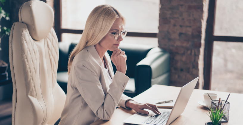 Learning analytics software helps identify students who need support Training manager reviewing student progress and learning analytics on a laptop.