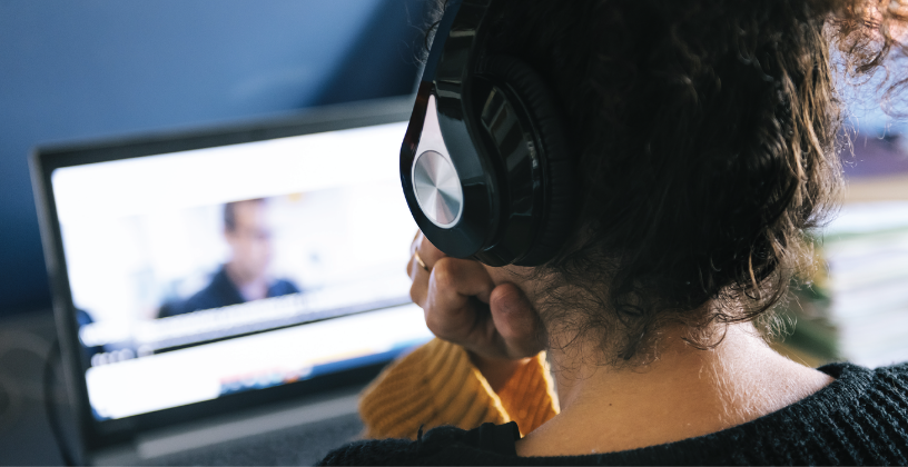 Microlearning solutions make learning easier to manage Student watching a microlearning video lesson on a laptop while wearing headphones.